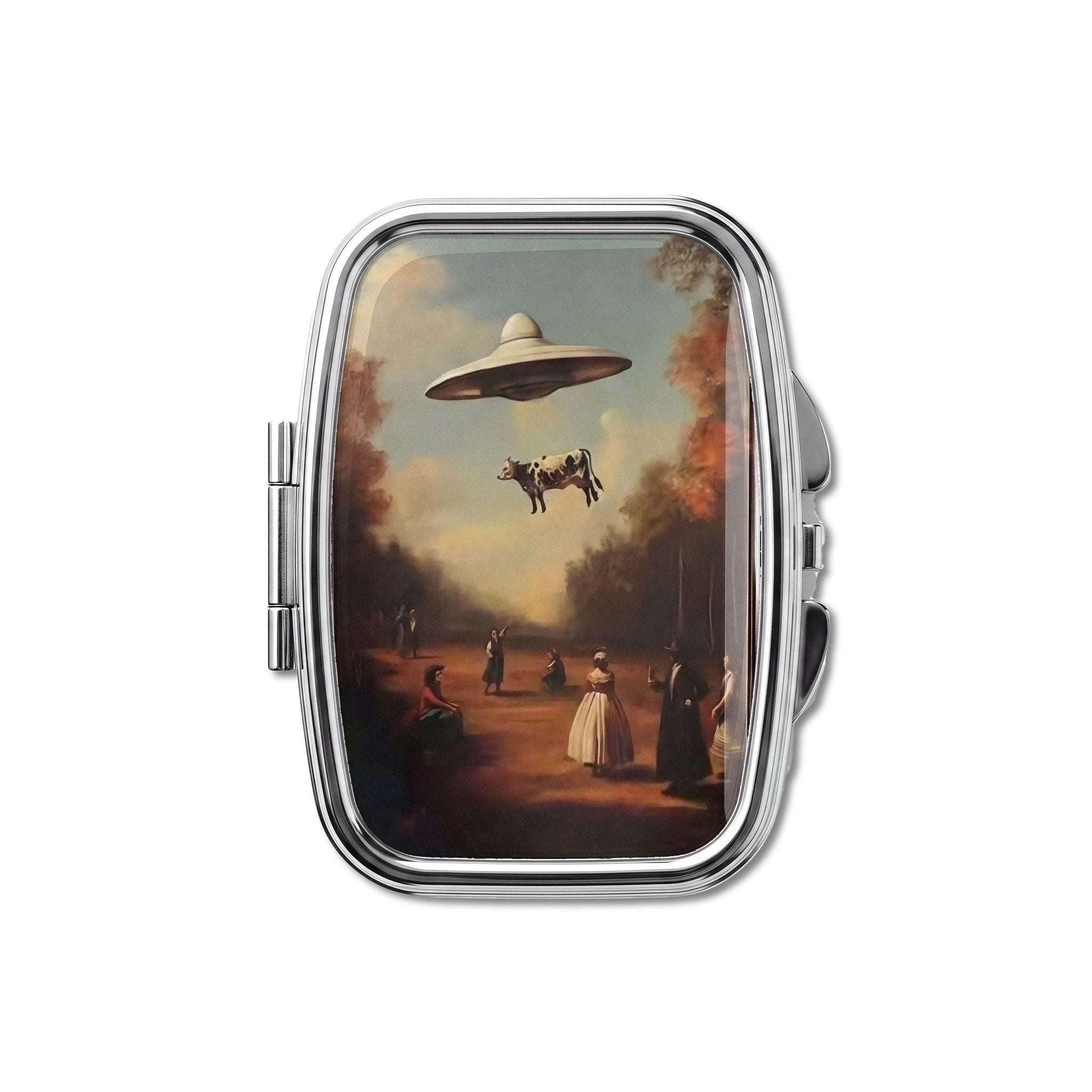 Bovine Abduction pill box, antique landscape with a flying saucer lifting a cow